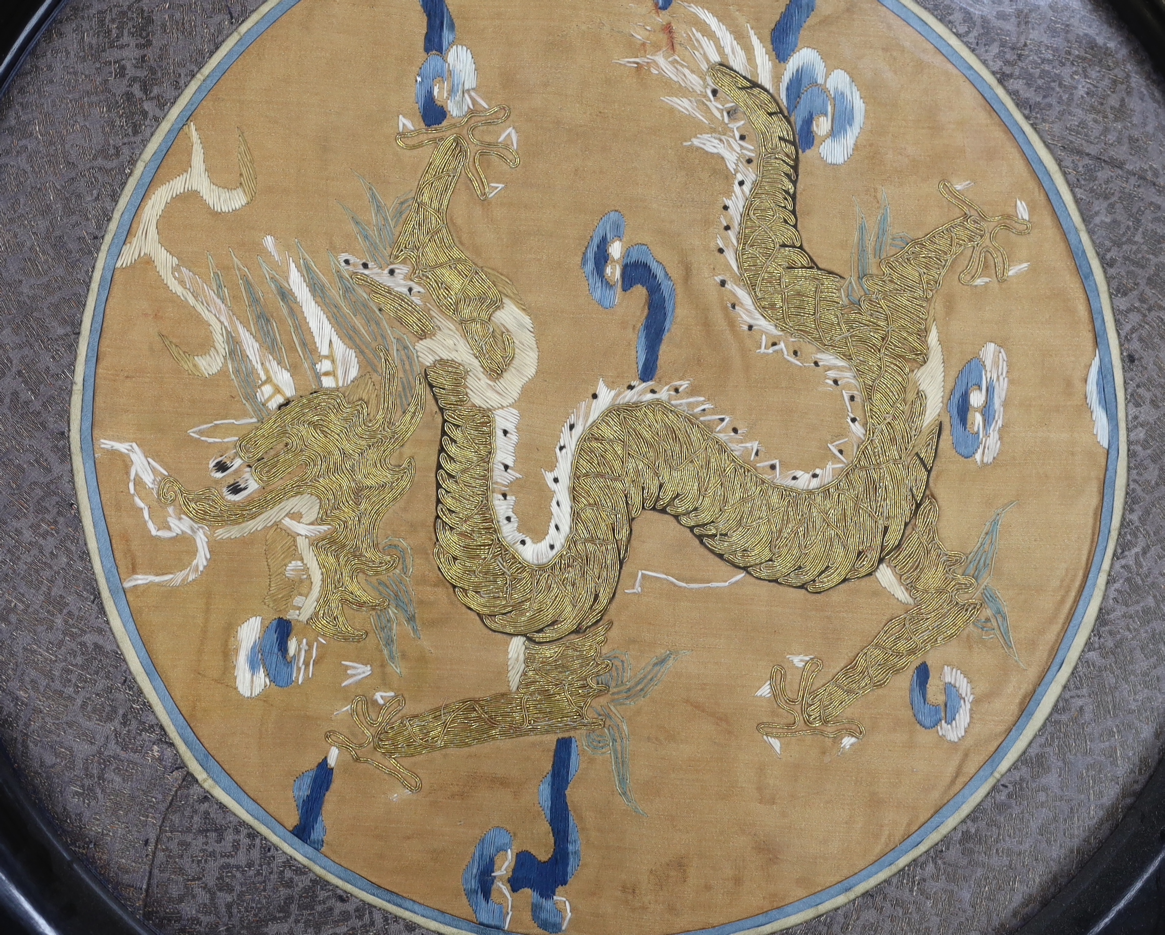 A Chinese circular ‘dragon’ embroidery, embroidered on silk in gold thread, slightly couched, framed 38cm diameter not including frame